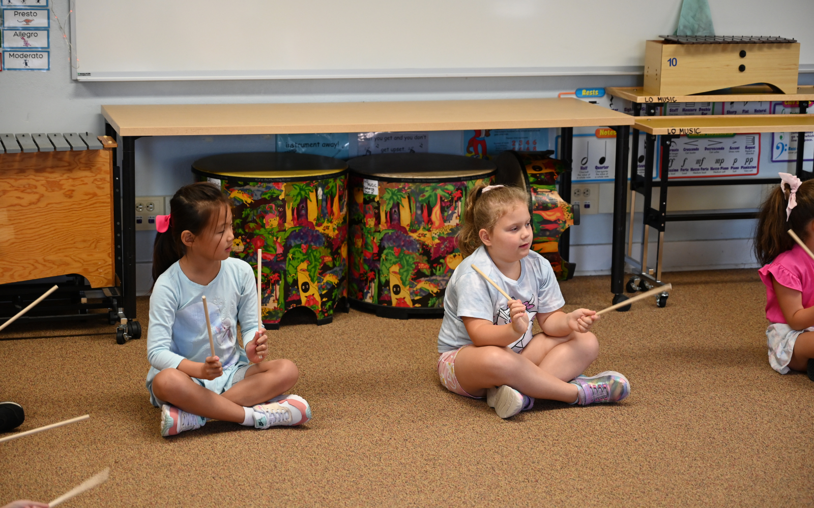 Elementary School student gets his hand painted during classroom art activity.