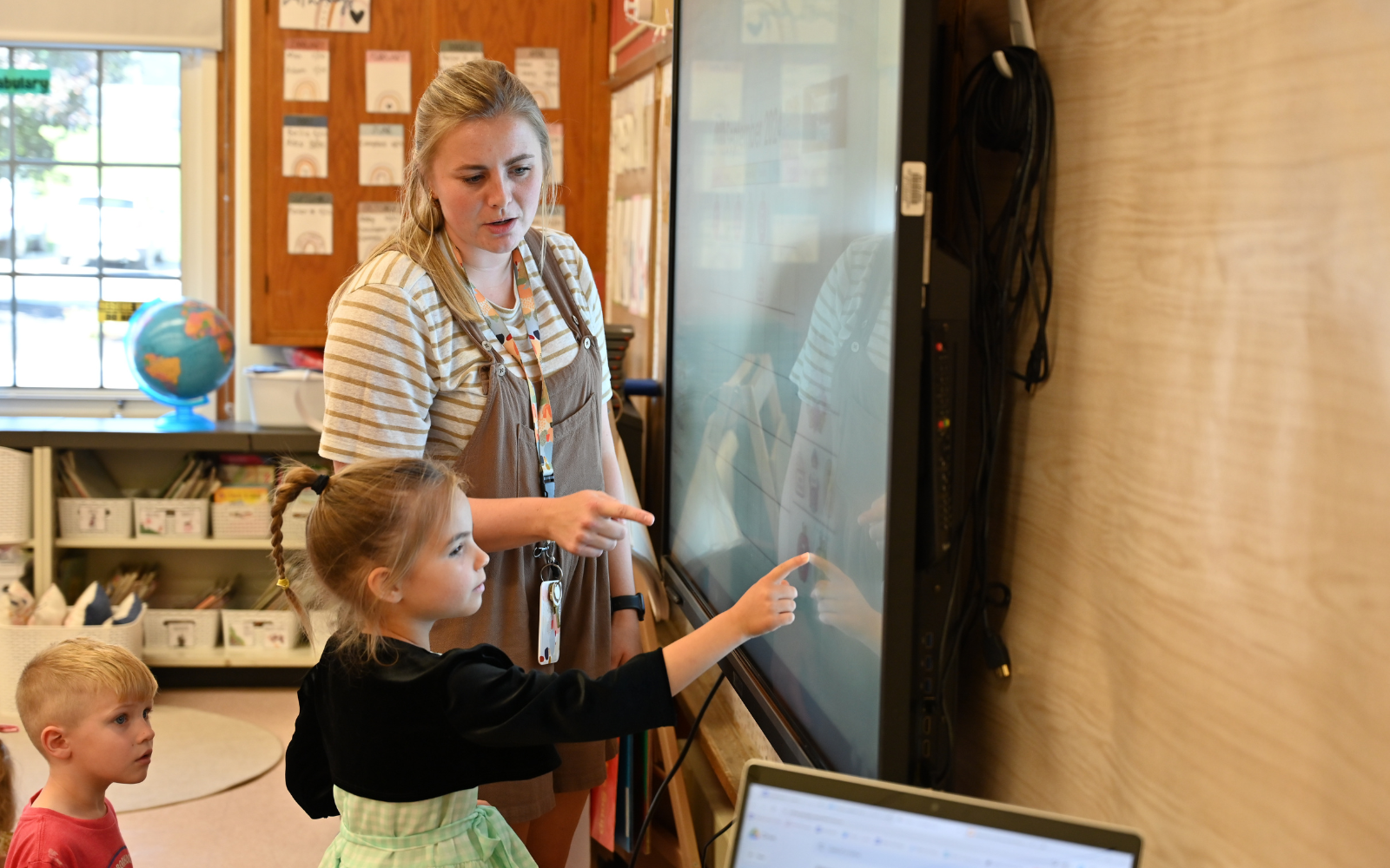 Elementary School student gets his hand painted during classroom art activity.