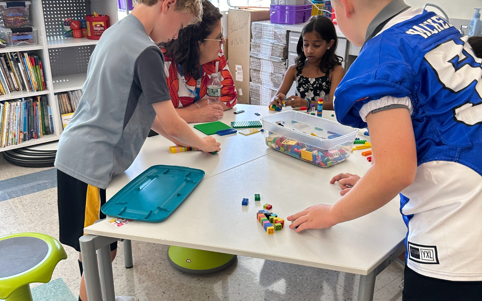 Elementary School student gets his hand painted during classroom art activity.