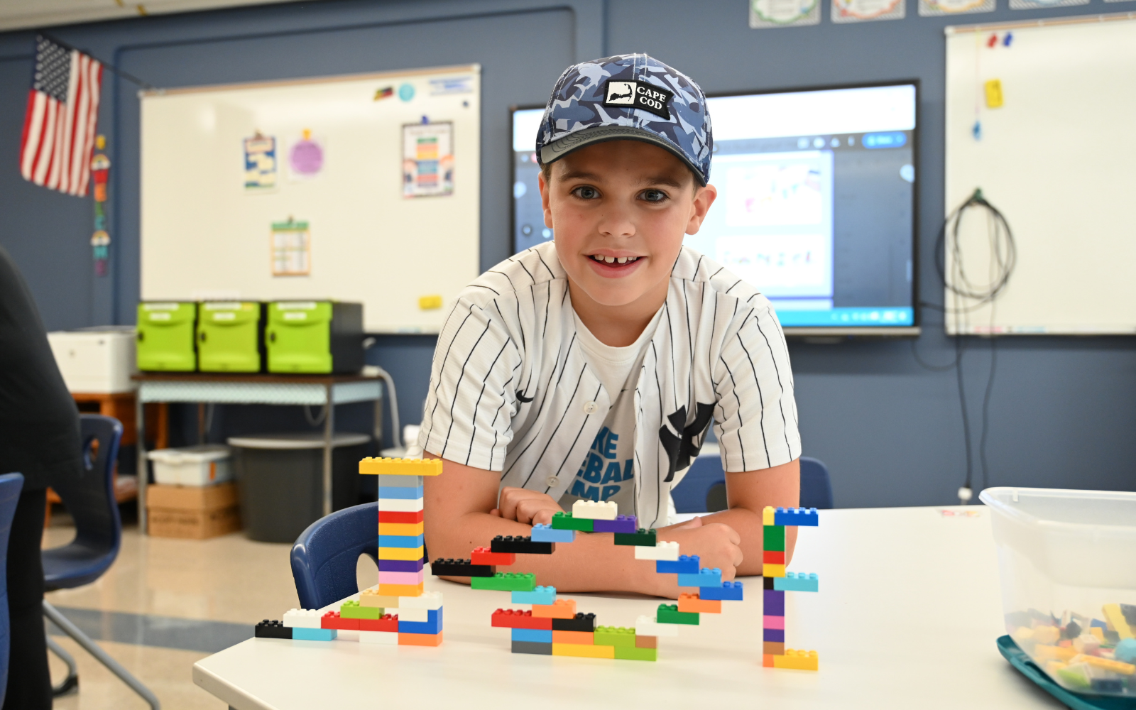 Elementary School student gets his hand painted during classroom art activity.