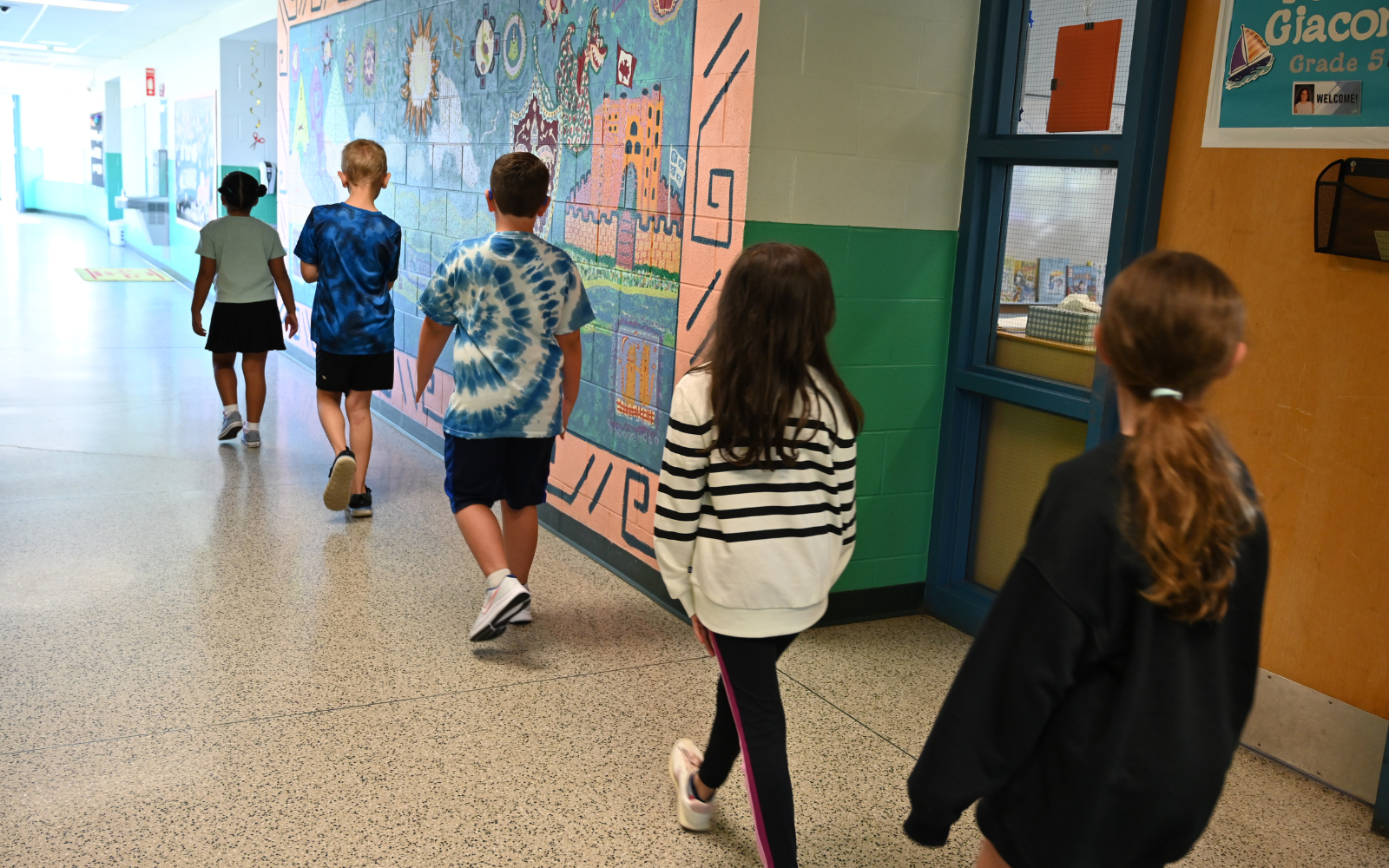 Elementary School student gets his hand painted during classroom art activity.