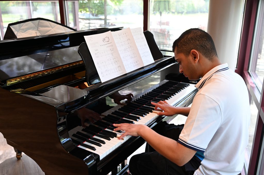 An image of a student playing the piano.