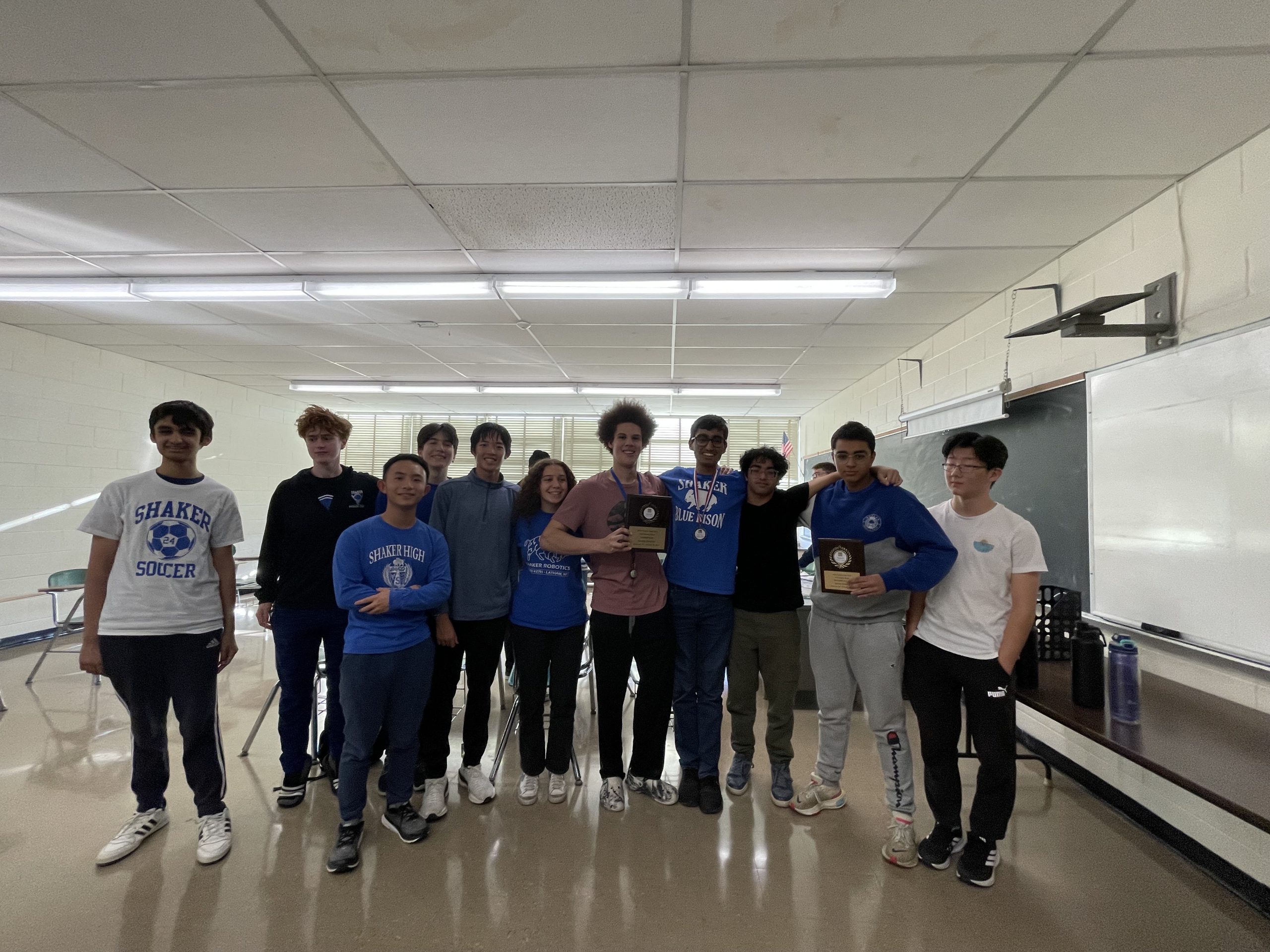 An image of a group of students holding the plaques they won competing in the CNY History Bowl & Bee.