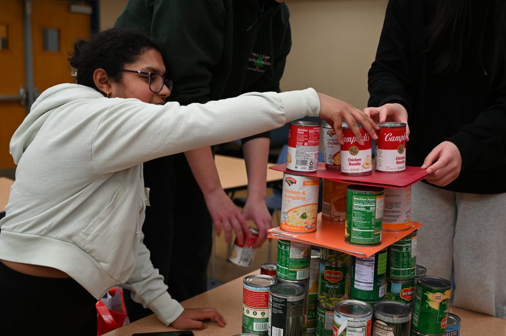 Student making tower of cans