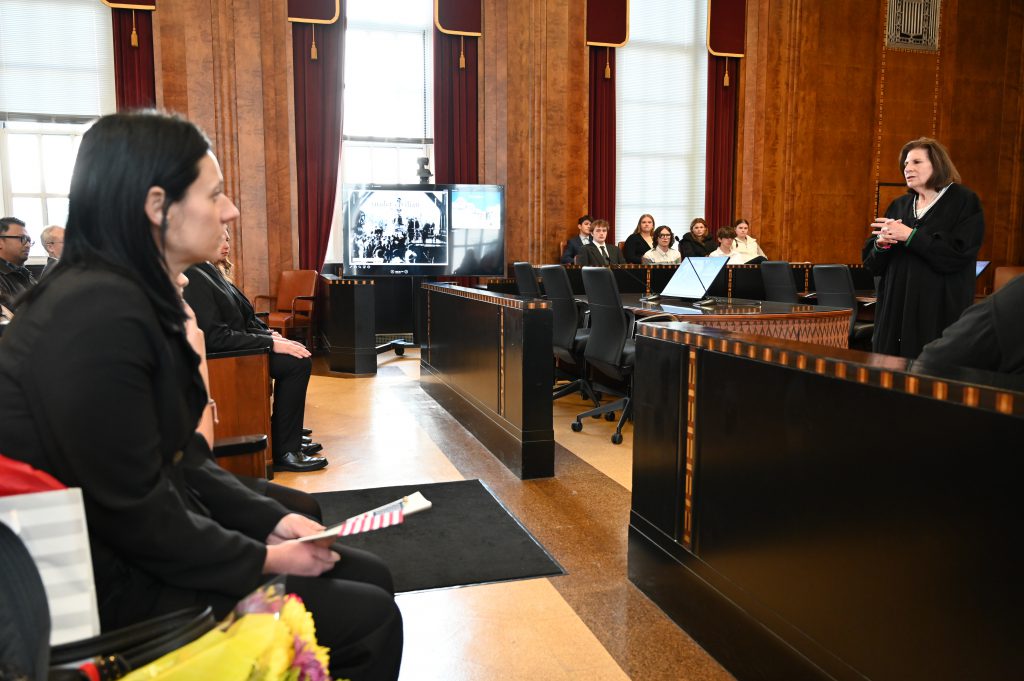 An image of a judge addressing people in her courtroom.