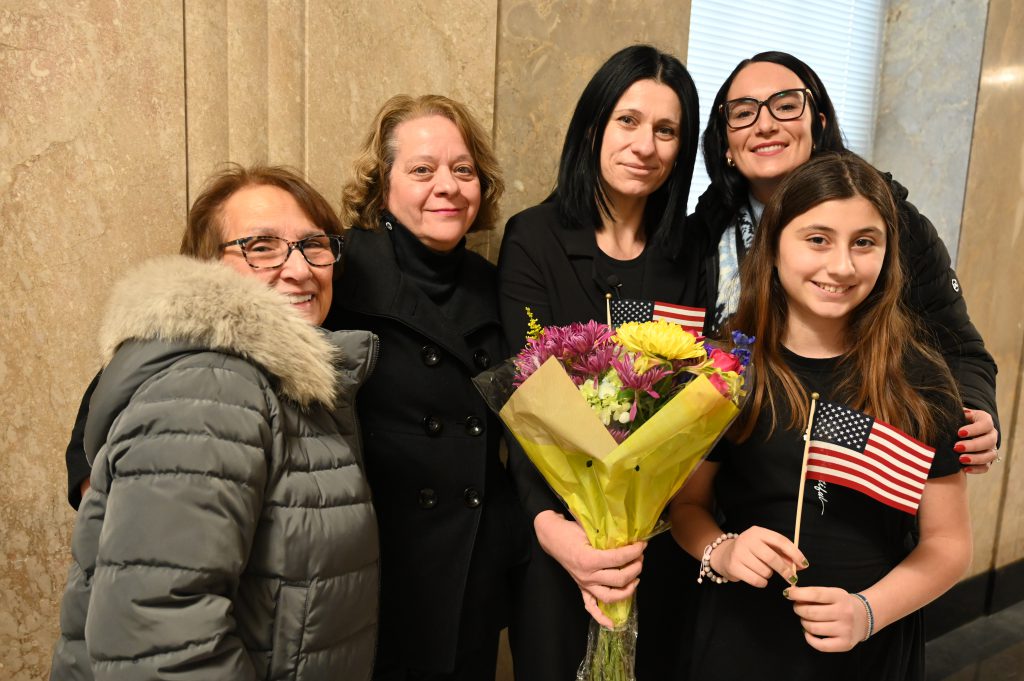 An image of five people posing together.