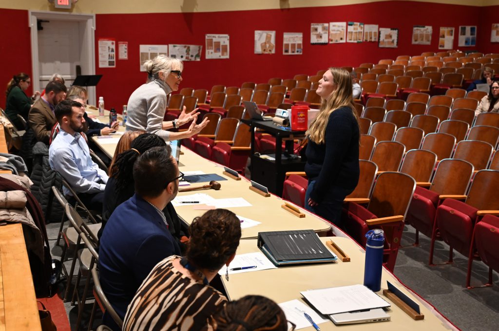 An image of a student being addressed by the Board of Education President as part of a recognition.