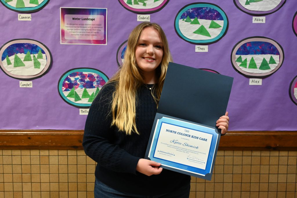 An image of a student holding a certificate.