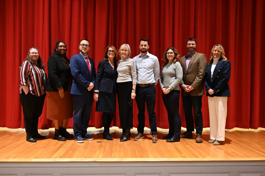 An image of nine members of the North Colonie Board of Education posing together.