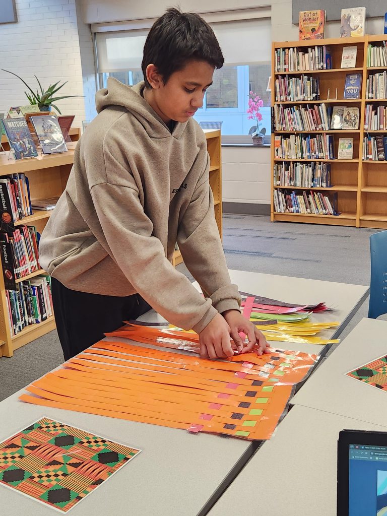 An image of a student creating a kente cloth.