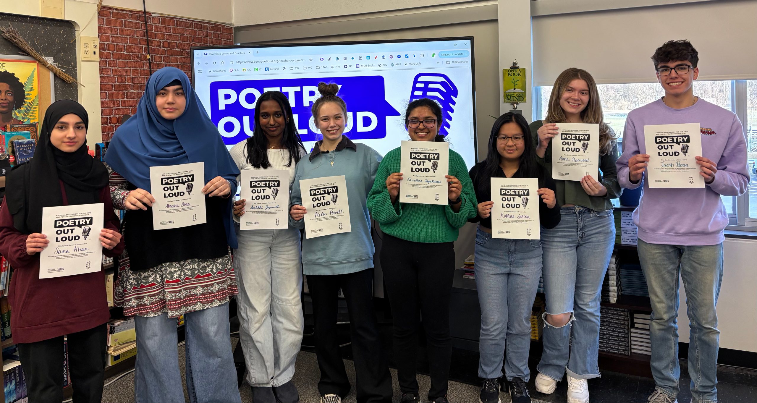 An image of eight Shaker students holding certificates for participating in Poetry Out Loud.