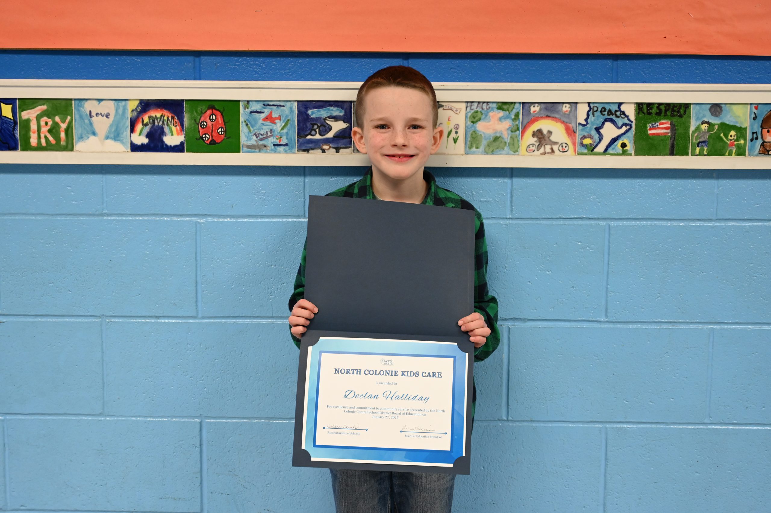 An image of a student holding a certificate.