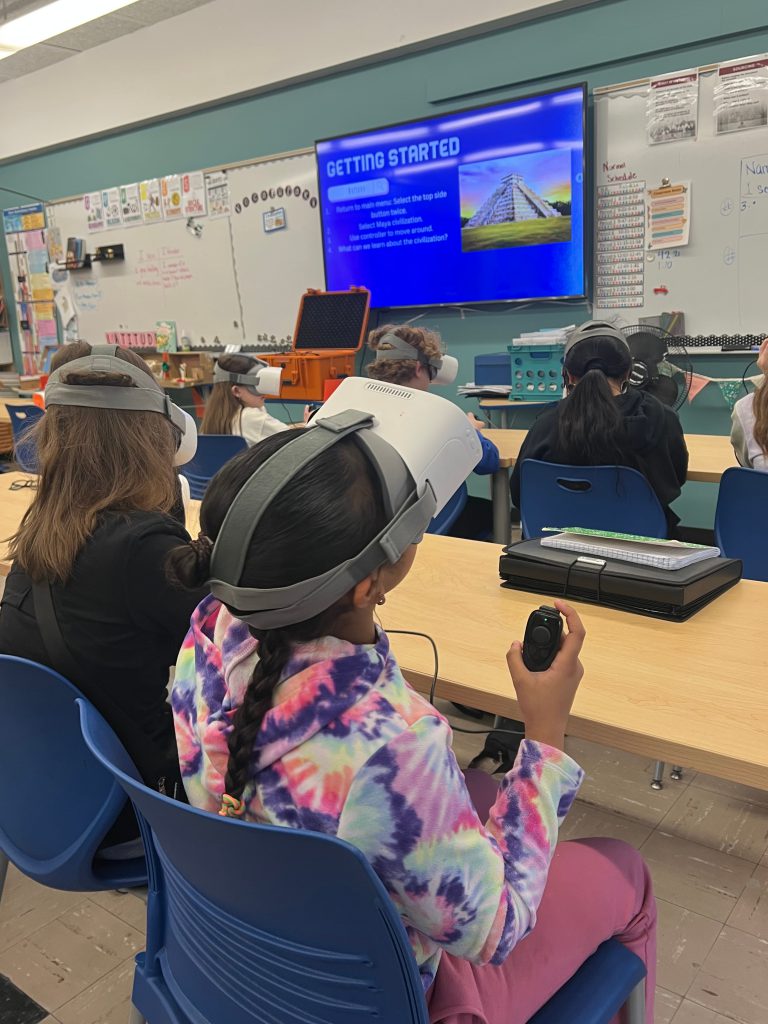 An image of students with virtual reality headsets on in a classroom.