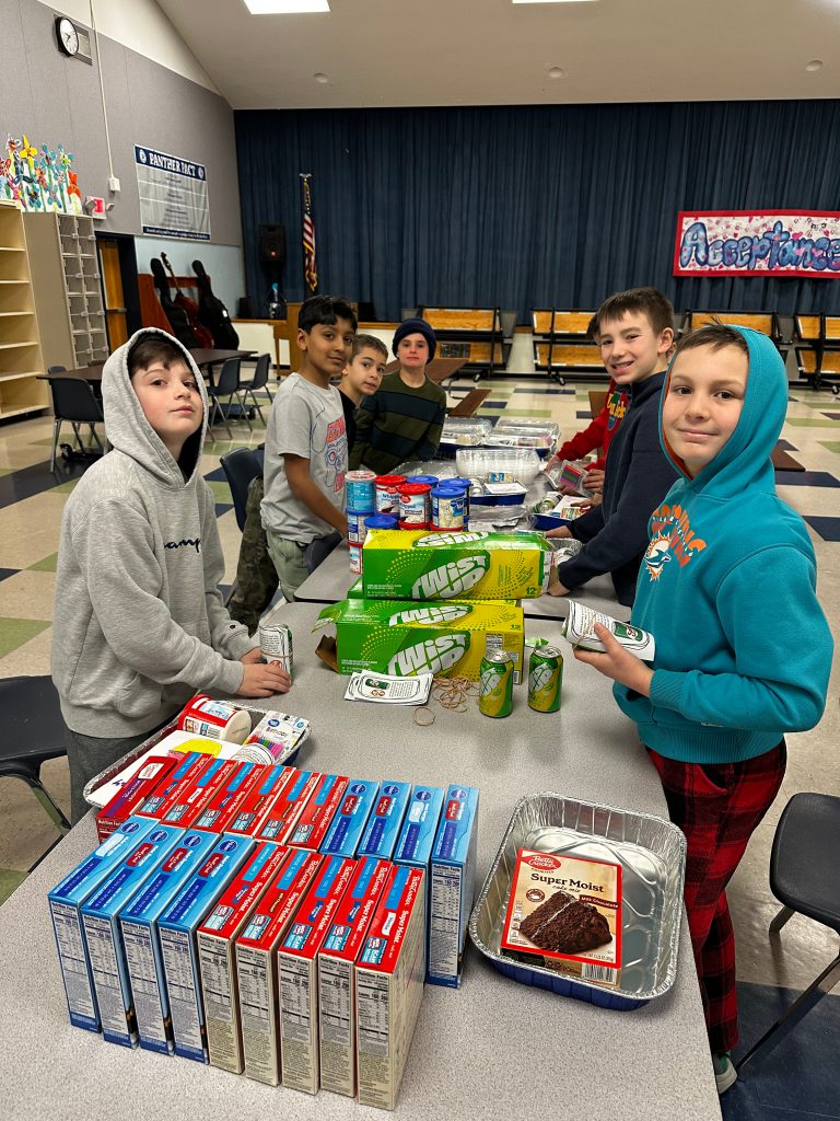 An image of students sorting items on a table.