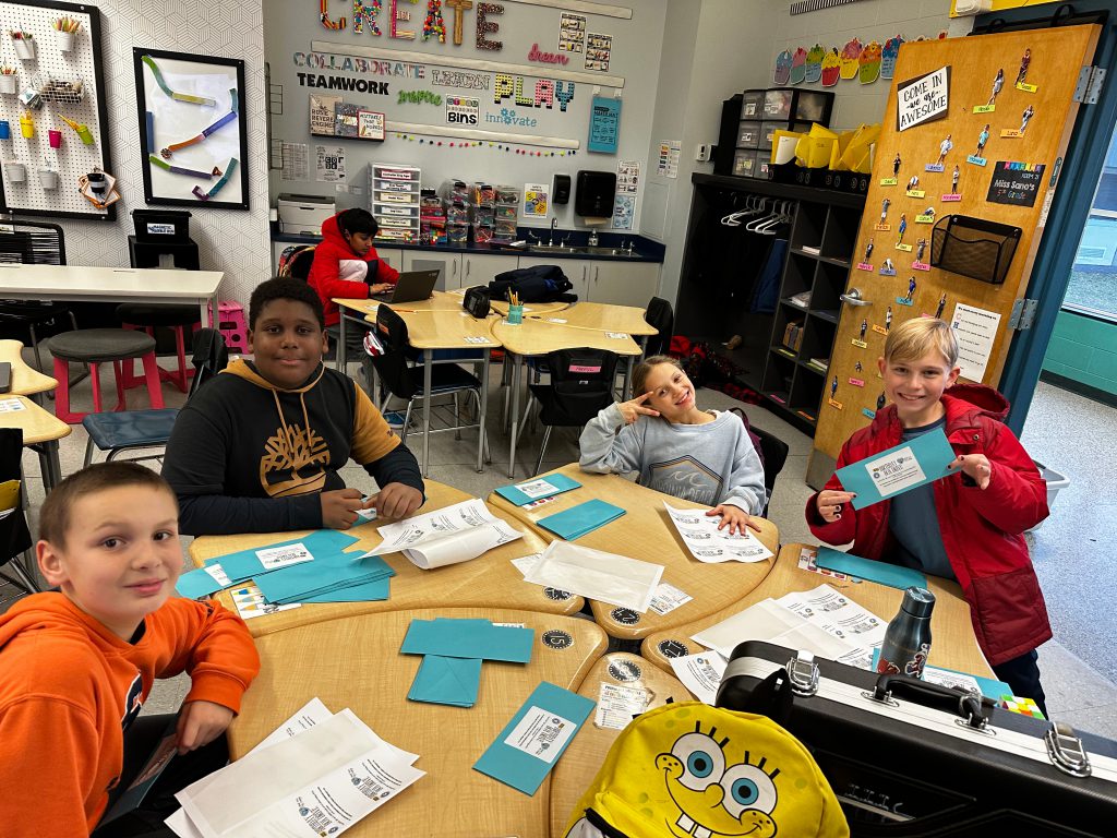 An image of four students creating handmade birthday cards.