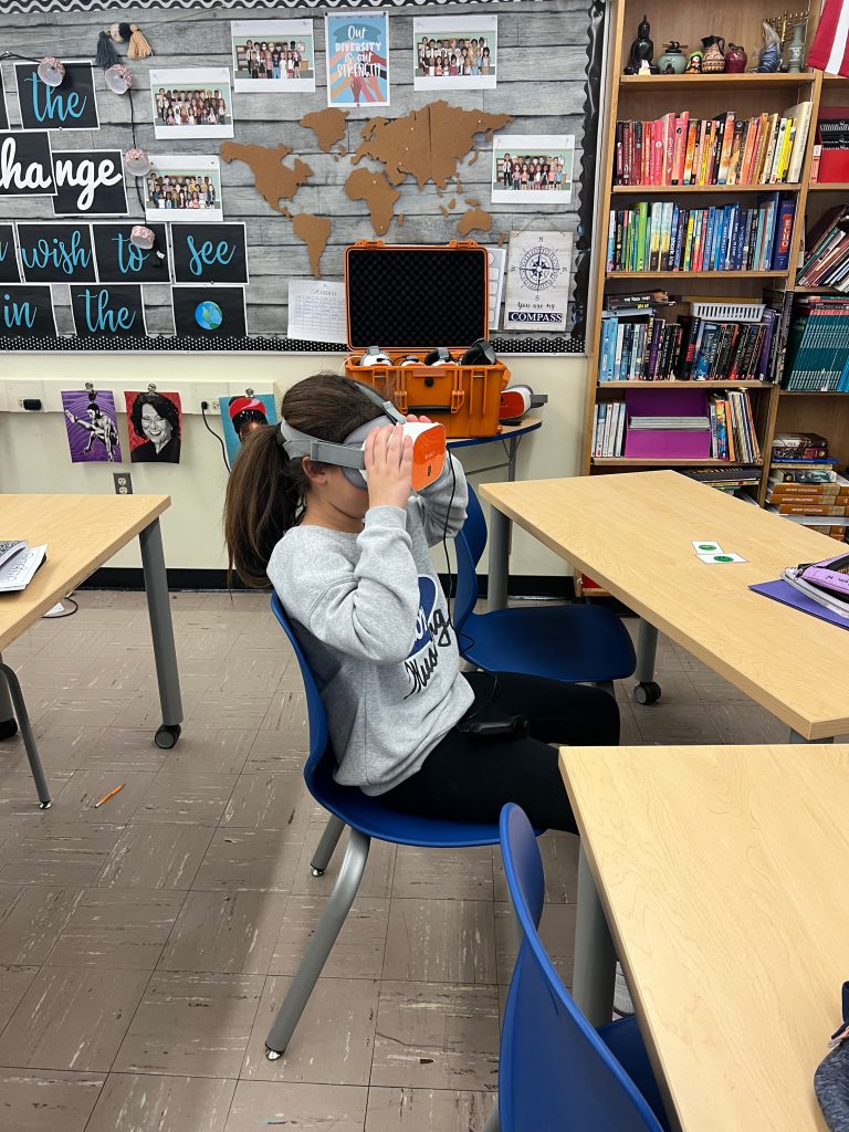 An image of a student with a virtual reality headset on.