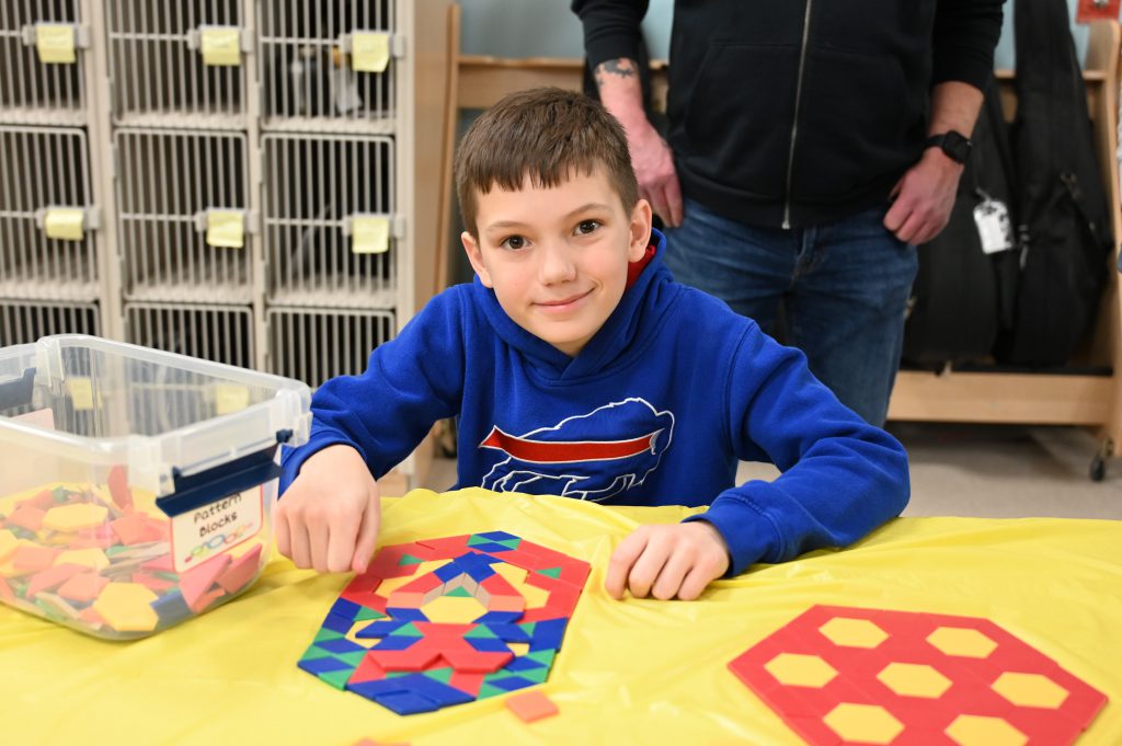 An image of a student creating a project using tiles.