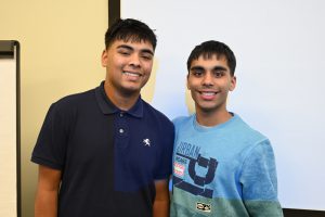 Two students smiling