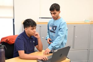 Two students look at computer