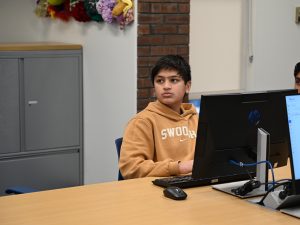 Student looks at screen to learn java