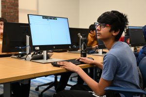 A student looks at screen to learn java coding at the library