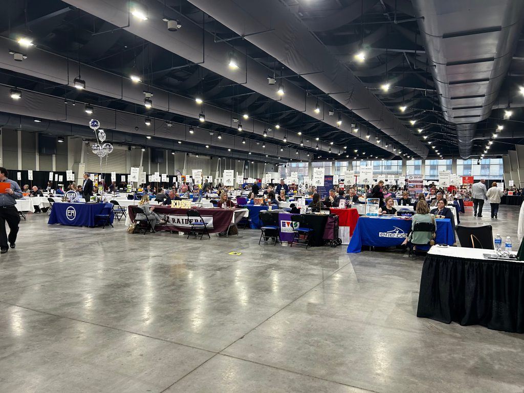 An image of hundreds of tables set up in a large warehouse style room.